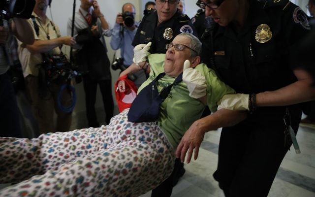 People are removed from a sit-in outside of Senate Majority Leader Mitch McConnell's office as they protest proposed cuts to Medicaid, Thursday, June 22, 2017 on Capitol Hill in Washington. (AP Photo/Jacquelyn Martin)