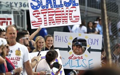 Supporters of House Majority Whip Steve Scalise, R-La., hold signs before the Congressional baseball game, Thursday, June 15, 2017, in Washington. The annual GOP-Democrats baseball game raises money for charity. (AP Photo/Alex Brandon)