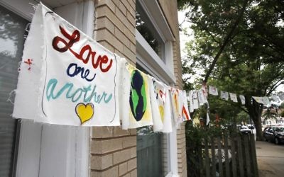 Painted cloth flags including one saying 'Love One Another' are strung across a store in Virginia on June 15, 2017, a day after Congressman Steve Scalise was shot during nearby during baseball practice. (AP Photo/Jacquelyn Martin)