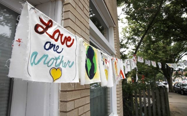 Painted cloth flags including one saying 'Love One Another' are strung across a store in Virginia on June 15, 2017, a day after Congressman Steve Scalise was shot during nearby during baseball practice. (AP Photo/Jacquelyn Martin) Painted cloth flags including one saying 'Love One Another' are strung across a store in Virginia on June 15, 2017, a day after Congressman Steve Scalise was shot during nearby during baseball practice. (AP Photo/Jacquelyn Martin)
