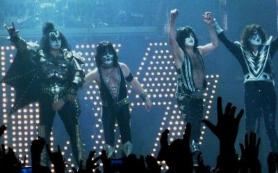 Gene Simmons (r) with the band KISS seen making the two-fingered gesture at LG Arena in Birmingham, UK on May 10, 2010. (CC BY-SA Andrew King, Flickr)