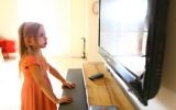 A young girl staring at a TV. (illustrative photo: Chen Leopold/Flash90)