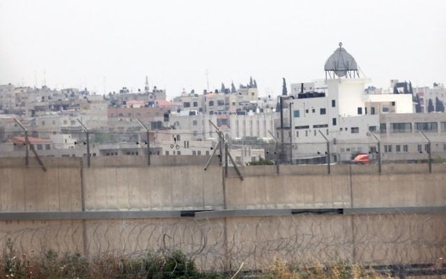 The West Bank town of Qalqilya is seen behind Israel's security barrier. (Yossi Zamir/Flash90) The West Bank town of Qalqilya is seen behind Israel's security barrier. (Yossi Zamir/Flash90)