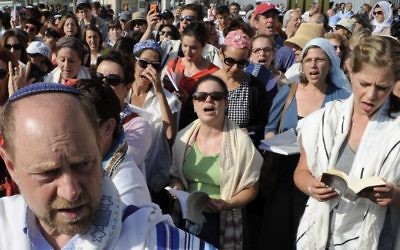 Men and women of the "Women of the Wall" organization wear prayer shawls and pray on the plaza near the Western Wall in Jerusalem on July 8, 2013. (Zuzana Janku/FLASH90)