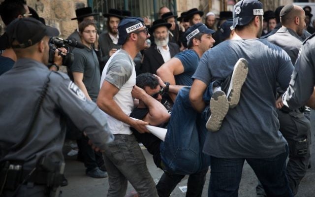 Israeli police officers carry a wounded policeman during an operation to arrest the attackers of ultra-Orthodox soldiers at the Meah Shearim neighborhood in Jerusalem on June 4, 2017. (Yonatan Sindel/Flash90) Israeli police officers carry a wounded policeman during an operation to arrest the attackers of ultra-Orthodox soldiers at the Meah Shearim neighborhood in Jerusalem on June 4, 2017. (Yonatan Sindel/Flash90)