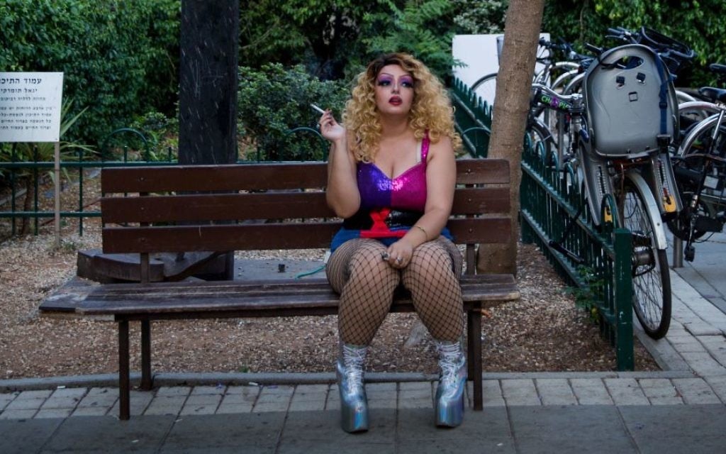A performer at the 'Wigstock Drag Queen Show' smokes a cigarette before the show at Meir Park, in Tel Aviv, as part of Gay Pride Week, on Wednesday, June 7, 2017 (Miriam Alster/FLASH90) A performer at the 'Wigstock Drag Queen Show' smokes a cigarette before the show at Meir Park, in Tel Aviv, as part of Gay Pride Week, on Wednesday, June 7, 2017 (Miriam Alster/FLASH90)