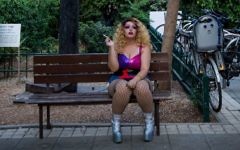A performer at the 'Wigstock Drag Queen Show' smokes a cigarette before the show at Meir Park, in Tel Aviv, as part of Gay Pride Week, on Wednesday, June 7, 2017 (Miriam Alster/FLASH90)