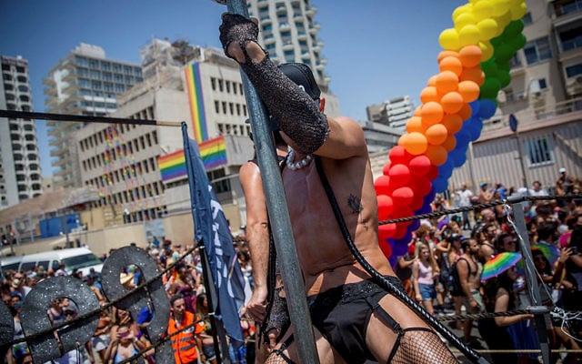 A man wearing fishnet tights dances at the annual Gay Pride Parade in Tel Aviv, on June 9, 2017. Friday's Parade marks the end of Pride Week in Tel Aviv, internationally acclaimed as one of the most proud and gay-friendly cities in the world. (Miriam Alster/Flash90)