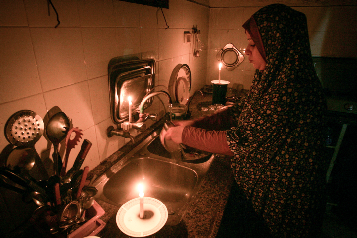 A Palestinian woman washes dishes by candlelight at her makeshift home in the Rafah refugee camp, in the southern Gaza Strip on June 12, 2017. (Abed Rahim Khatib/Flash90) A Palestinian woman washes dishes by candlelight at her makeshift home in the Rafah refugee camp, in the southern Gaza Strip on June 12, 2017. (Abed Rahim Khatib/Flash90)