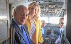 Prime Minister Benjamin Netanyahu and his wife, Sara, pose for a photo with pilot Nechama Spiegel Novak (right) before taking off from Ben Gurion International Airport to Greece, June 14, 2017. (Amos Ben Gershom/GPO)
