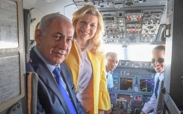 Prime Minister Benjamin Netanyahu and his wife, Sara, pose for a photo with pilot Nechama Spiegel Novak (right) before taking off from Ben Gurion International Airport to Greece, June 14, 2017. (Amos Ben Gershom/GPO)