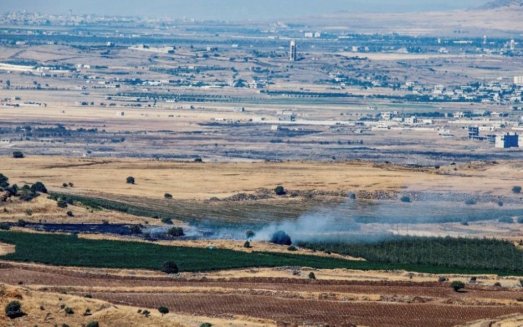 A picture taken from the Israeli side of the border shows smoke rising near the Israeli-Syrian border in the Golan Heights during fights between the rebels and the Syrian army on June 25, 2017. (Basel Awidat/Flash90) A picture taken from the Israeli side of the border shows smoke rising near the Israeli-Syrian border in the Golan Heights during fights between the rebels and the Syrian army on June 25, 2017. (Basel Awidat/Flash90)