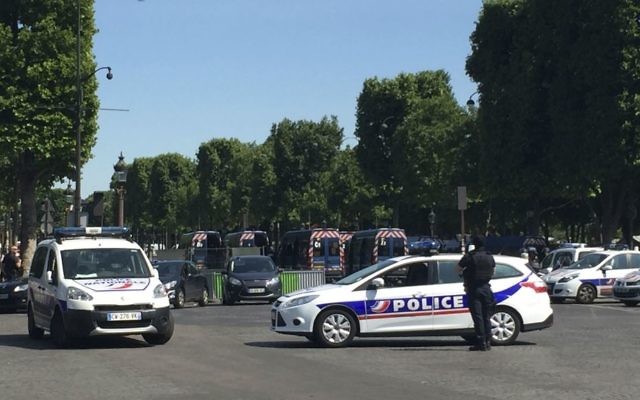 Police vehicles prevent access to the Champs Elysees avenue in Paris, France, Monday, June 19, 2017. (AP Photo/Bertrand Combaldieu)