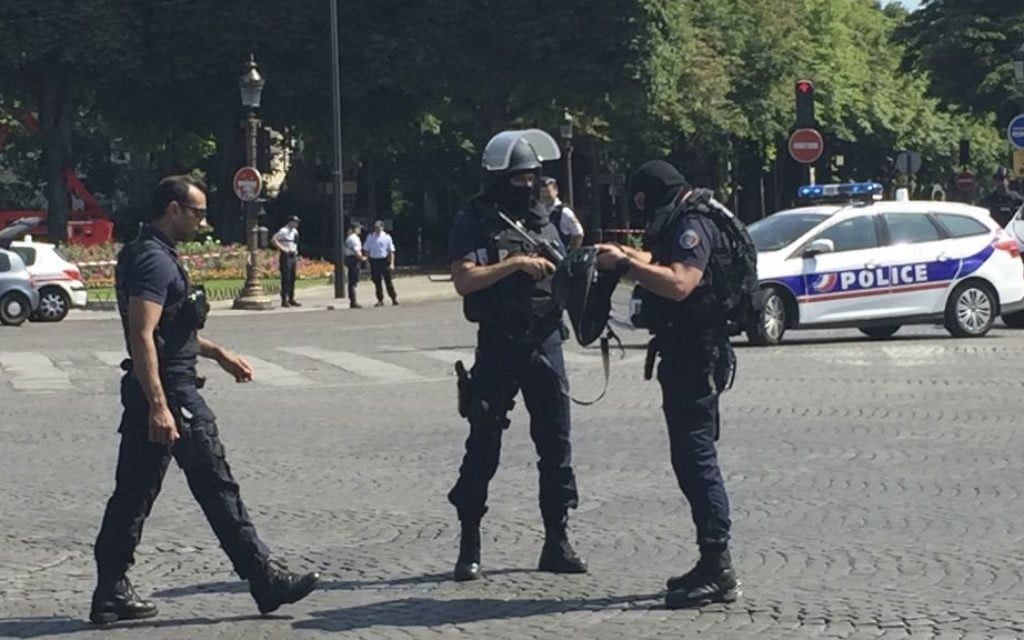 Police officers seal off access to the Champs Elysees avenue in Paris, France, Monday, June 19, 2017. (AP Photo/Bertrand Combaldieu)