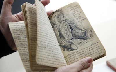 Curator Kyra Schuster, shows diaries laid on a table at the Holocaust Memorial Museum in Washington, Wednesday, June 7, 2017. (AP Photo/Manuel Balce Ceneta)