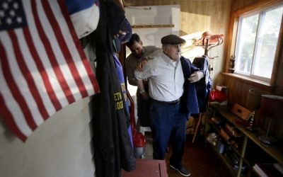 In this Wednesday, June 7, 2017, photo, Holocaust survivor Steve Ross, right, is helped with his jacket by his son Mike Ross, behind, as they prepare to depart Steven Ross' home in Newton, Mass., to attend the premier of the film "Etched in Glass: The Legacy of Steve Ross." (AP Photo/Steven Senne) In this Wednesday, June 7, 2017, photo, Holocaust survivor Steve Ross, right, is helped with his jacket by his son Mike Ross, behind, as they prepare to depart Steven Ross' home in Newton, Mass., to attend the premier of the film "Etched in Glass: The Legacy of Steve Ross." (AP Photo/Steven Senne)