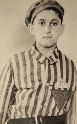 In this undated World War II-era photograph provided by Many Hats Productions, Holocaust survivor Steve Ross wears a Nazi prison camp uniform. (courtesy of the family via Many Hats Productions via AP) In this undated World War II-era photograph provided by Many Hats Productions, Holocaust survivor Steve Ross wears a Nazi prison camp uniform. (courtesy of the family via Many Hats Productions via AP)