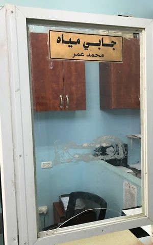 The vacant desk of Kusra's water attendent, Muhammad Amar on June 4, 2017. Amar has not had any work since the water was shut off in Kusra. (Jacob Magid/Times of Israel)