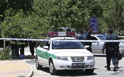 The body of a suspected terrorist, at background left, lies on the ground while police control the scene at the shrine of late Iranian revolutionary founder Ayatollah Khomeini, just outside Tehran, Iran, Wednesday, June 7, 2017 (AP Photo/Ebrahim Noroozi) The body of a suspected terrorist, at background left, lies on the ground while police control the scene at the shrine of late Iranian revolutionary founder Ayatollah Khomeini, just outside Tehran, Iran, Wednesday, June 7, 2017 (AP Photo/Ebrahim Noroozi)