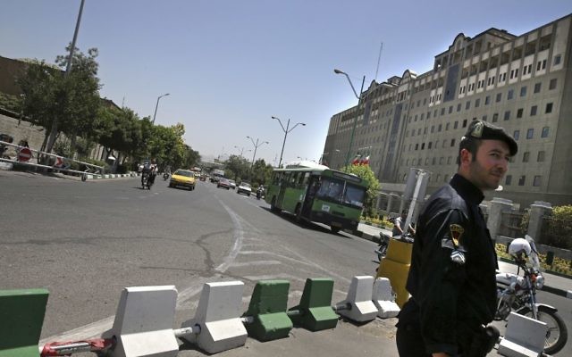 A police officer stands guard as vehicles drive in front of Iran's parliament building in Tehran, Iran, Thursday, May 8, 2017. (AP/Vahid Salemi) A police officer stands guard as vehicles drive in front of Iran's parliament building in Tehran, Iran, Thursday, May 8, 2017. (AP/Vahid Salemi)