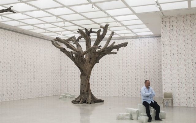 Chinese artist Ai Weiwei sits before the opening of his exhibition in the Israel Museum in Jerusalem, Thursday, June 1, 2017. (AP Photo/Dan Balilty)