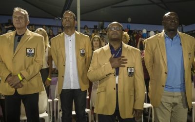 In this Thursday, June 15, 2017 photo, former NFL players, from left, Joe Montana, Andre Reed, Mike Singletary and Bruce Smith attend a football game in Ramat Hasharon, near Tel Aviv, Israel. (AP Photo/Tsafrir Abayov)