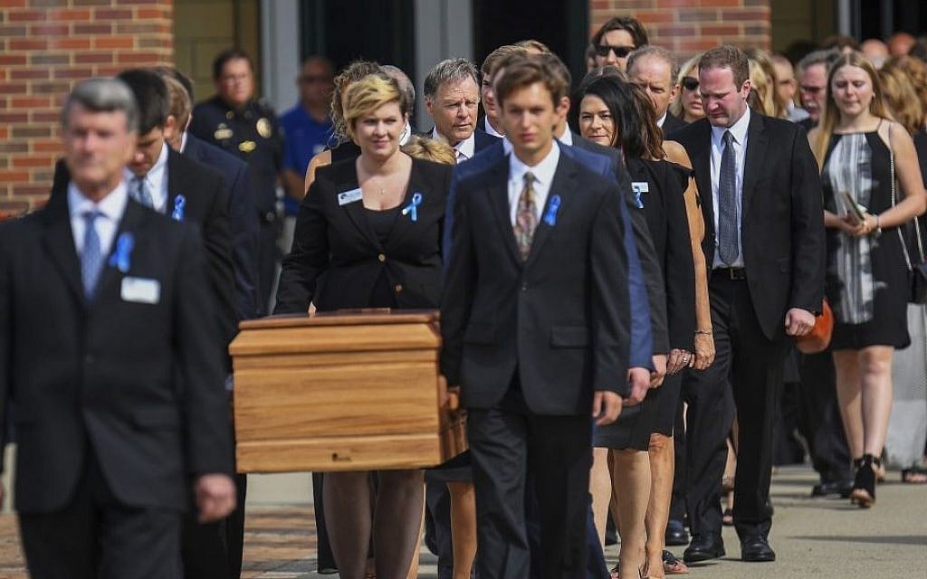 The casket of Otto Warmbier is carried from Wyoming High School after his funeral, Thursday, June 22, 2017, in Wyoming, Ohio. (AP Photo/Bryan Woolston)