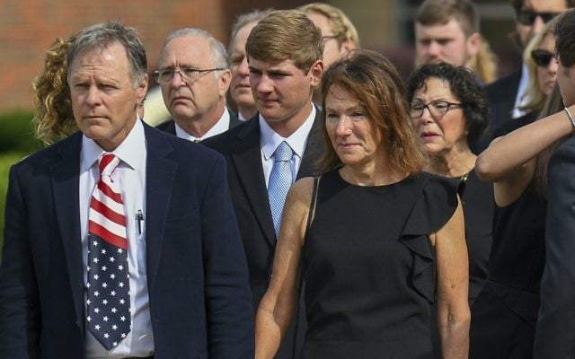 Fred and Cindy Warmbier watch as their son Otto is placed in a hearse after his funeral, Thursday, June 22, 2017, in Wyoming, Ohio. (AP Photo/Bryan Woolston)