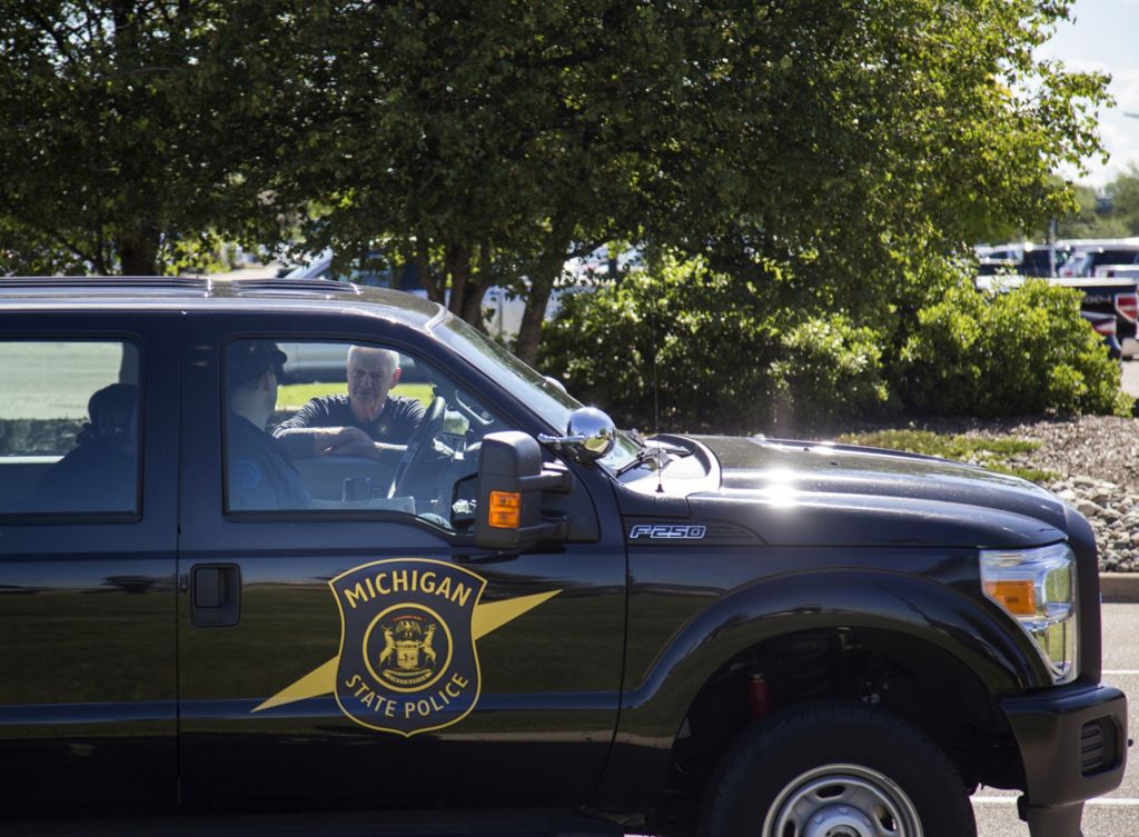 Officer Injured-Airpo_Horo (1) Michigan State Police talk outside Bishop International Airport, Wednesday morning, June 21, 2017, in Flint, Mich. (Shannon Millard/The Flint Journal-MLive.com via AP)