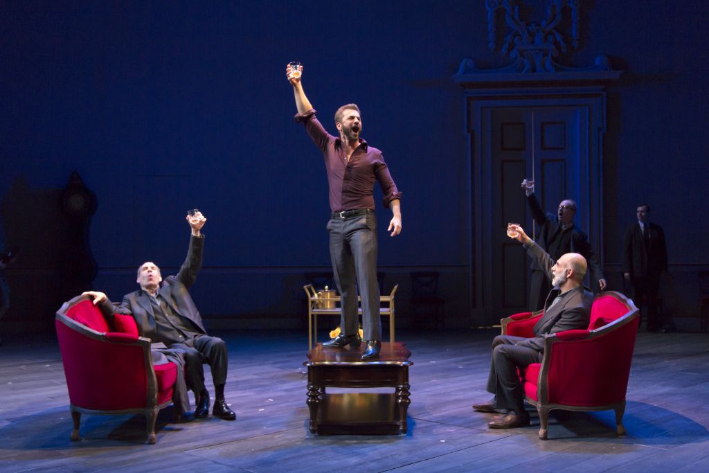 Michael Aronov the the iconic table scene, with Daniel Oreskes, and Anthony Azizi (foreground), and Daniel Jenkins and Jeb Kreager (background) in 'OSLO.' (Courtesy) Michael Aronov the the iconic table scene, with Daniel Oreskes, and Anthony Azizi (foreground), and Daniel Jenkins and Jeb Kreager (background) in 'OSLO.' (Courtesy)