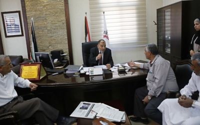In this Monday, June 5, 2017 photo, the Mayor of Hebron Tayseer Abu Sneineh meets constituents at his office in the West Bank city of Hebron. (AP/Nasser Shiyoukhi)