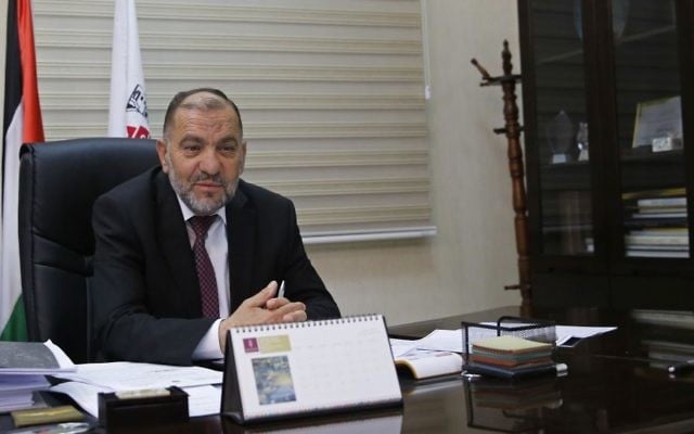 In this Monday, June 5, 2017 photo, mayor of Hebron Tayseer Abu Sneineh meets constituents at his office in the West Bank city of Hebron. (AP/Nasser Shiyoukhi).
