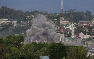 Debris fly as Philippine Air Force fighter jets bomb suspected locations of Muslim militants as fighting continues in Marawi city, southern Philippines, Friday, June 9, 2017.  (AP Photo/Aaron Favila)