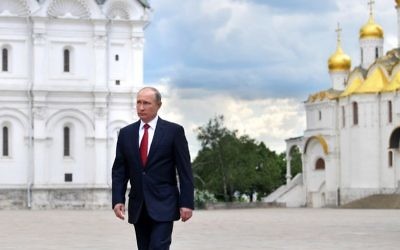 Russian President Vladimir Putin walks along the Cathedral Square of the Kremlin, to take part in a holiday reception in Moscow, Monday, June 12, 2017. (Alexei Druzhinin/Sputnik, Kremlin Pool Photo via AP)