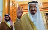 Saudi King Salman, right, and Defense Minister and then Deputy Crown Prince Mohammed bin Salman wave as they leave the hall after talks with the British prime minister, in Riyadh, Saudi Arabia, April 5, 2017 (Saudi Press Agency via AP)