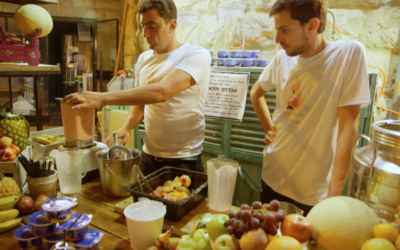 Health food company representatives prepare protein smoothies at a ShukTech event in Jerusalem, June 21, 2017. (Micah Danney/Times of Israel)