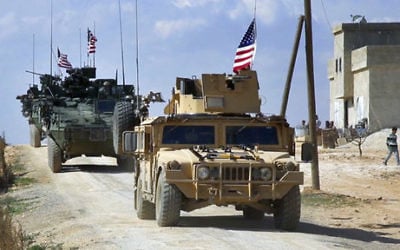 This March 7, 2017 frame grab from video provided by Arab 24 network shows US forces patrolling on the outskirts of the Syrian town of Manbij, in Aleppo province, Syria. (Arab 24 network, via AP, File)