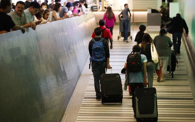 Travelers make their way up the arrival ramp at the Tom Bradley International Terminal at the Los Angeles International Airport Thursday, June 29, 2017, in Los Angeles (AP Photo/Jae C. Hong) Travelers make their way up the arrival ramp at the Tom Bradley International Terminal at the Los Angeles International Airport Thursday, June 29, 2017, in Los Angeles (AP Photo/Jae C. Hong)