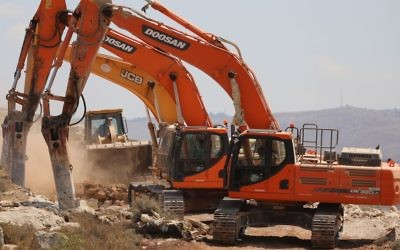 Construction workers begin work on the new settlement, Amichai, meant to resettle the evacuees of Amona, June 20, 2017. (Yonatan Sindel/Flash90)