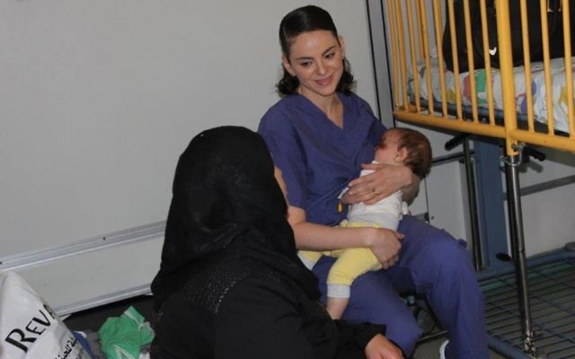 Nurse Ula Ostrowski-Zak cares for a nine-month-old Palestinian boy at Hadassah Ein Kerem Hospital in Jerusalem. (Hadassah spokesperson) Nurse Ula Ostrowski-Zak cares for a nine-month-old Palestinian boy at Hadassah Ein Kerem Hospital in Jerusalem. (Hadassah spokesperson)