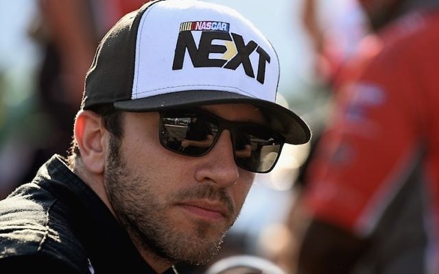  Alon Day, driver of the #40 FL Waterfront.com Dodge, sits next to his car during qualifying for the NASCAR XFINITY Series 4th Annual Mid-Ohio Challenge at Mid-Ohio Sports Car Course on August 12, 2016 in Lexington, Ohio. (Jonathan Moore/Getty Images via JTA)