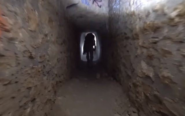 A man walks through catacombs under Paris (YouTube screenshot) A man walks through catacombs under Paris (YouTube screenshot)