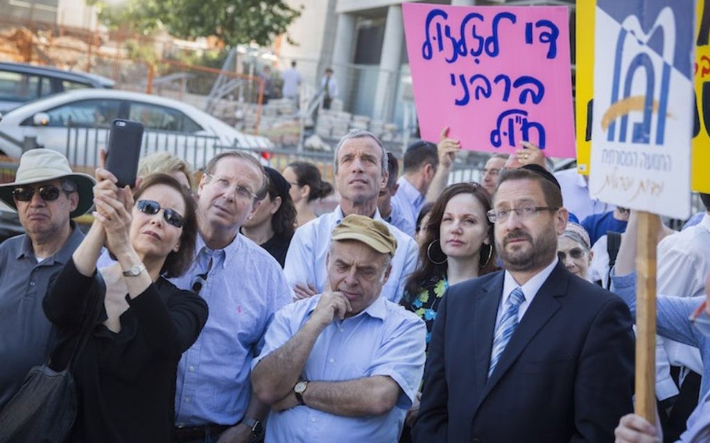 Then-Jewish Agency chairman Natan Sharansky, center, in brown cap, and then-Knesset member Dov Lipman, in jacket and tie at right, at a protest held by American and Israeli Orthodox and Conservative Jews outside the Chief Rabbinate offices in Jerusalem, July 6, 2016. (Hadas Parush/Flash90) Then-Jewish Agency chairman Natan Sharansky, center, in brown cap, and then-Knesset member Dov Lipman, in jacket and tie at right, at a protest held by American and Israeli Orthodox and Conservative Jews outside the Chief Rabbinate offices in Jerusalem, July 6, 2016. (Hadas Parush/Flash90)