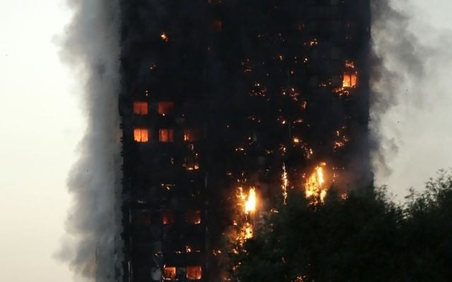 Smoke and flames rise from a building on fire in London, Wednesday, June 14, 2017. (AP Photo/Matt Dunham)