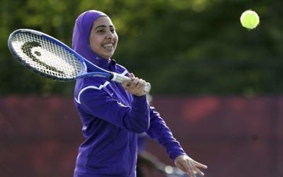Tabarek Kadhim, a student at Deering High School in Portland, Maine, wears a sports hijab while playing a tennis match in Windham, Maine in 2017. (AP Photo/Robert F. Bukaty)