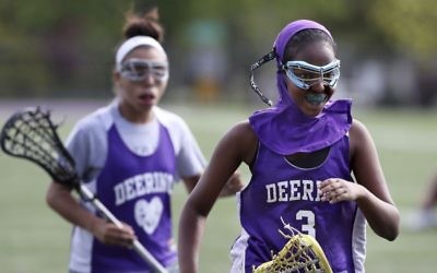 In this May 24, 2017 photo, Fadumo Adan, a lacrosse player at Deering High School, wears a sports hijab provided by the school during practice in Portland, Maine. (AP Photo/Robert F. Bukaty)