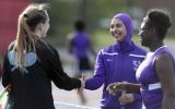 In this May 24, 2017 photo, Tabarek Kadhim, center, congratulates an opponent after a tennis match in Windham, Maine. (AP Photo/Robert F. Bukaty)