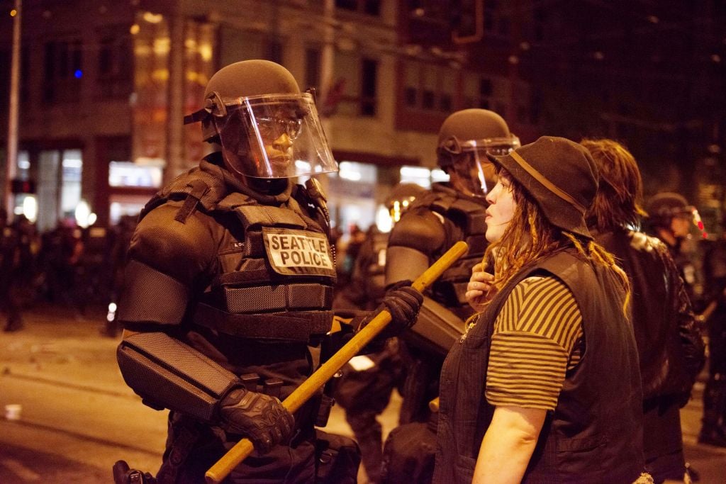 Illustrative: A woman faces off with a Seattle police officer on Capitol Hill during a May Day protest. (istockphotos) Illustrative: A woman faces off with a Seattle police officer on Capitol Hill during a May Day protest. (istockphotos)