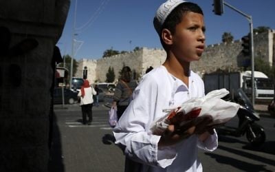A Palestinian boy walks in East Jerusalem, May 31, 2017. (AFP Photo/Ahmad Gharabli)