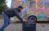 A screenshot from a music video showing a bus painted with Jewish symbols by Brooklyn artist Lev “Leviticus” Schieber.